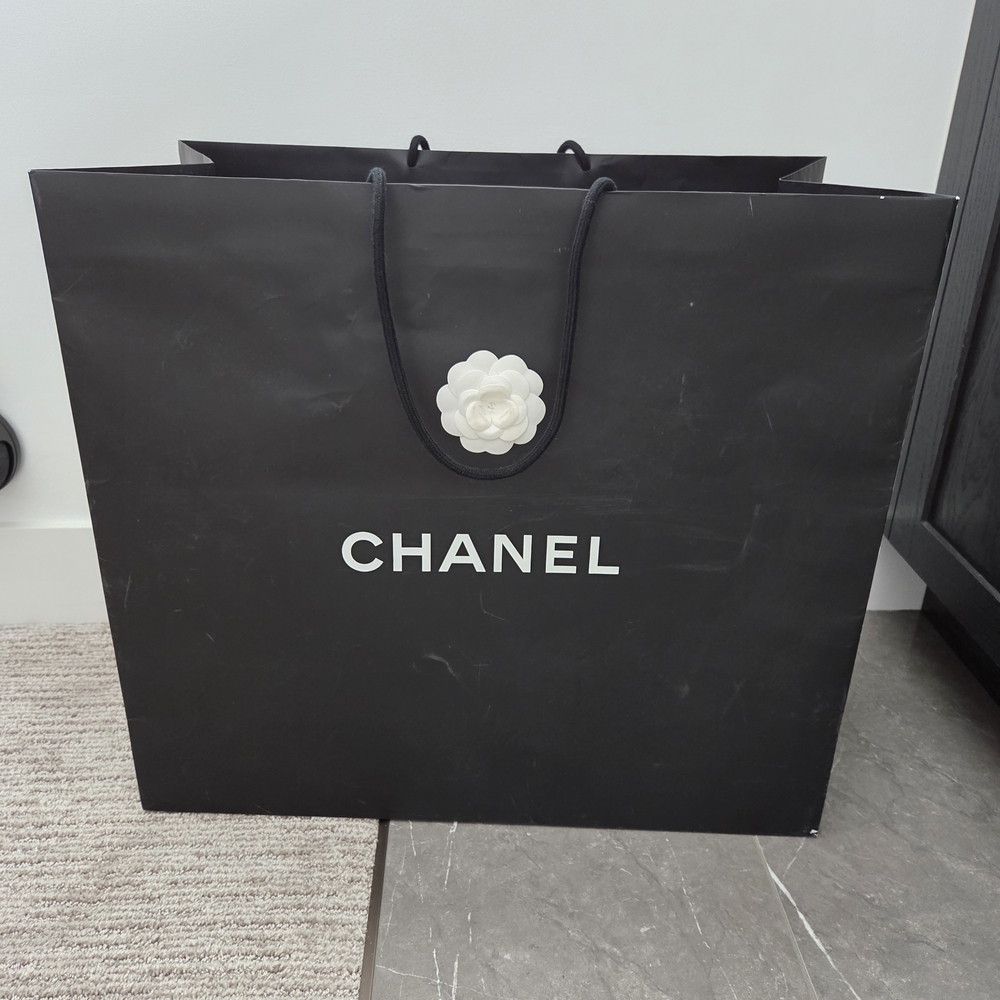 CHANEL Black Bag with White Flower Accent